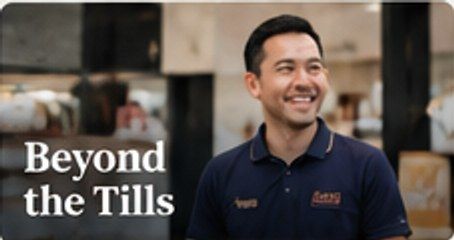 Temporary mock-up image: a smiling retail worker in a shop.