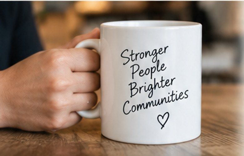 Temporary mock-up image: hands holding a white mug on a wooden table.